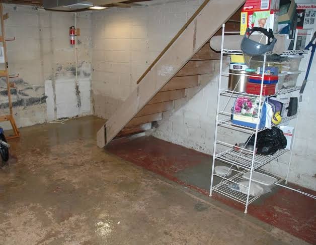 Basement Foundation Water Stains and Concrete Slab Moisture Water line stains and residual moisture along basement concrete foundation wall and concrete slab floor after flooding
