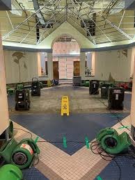 Commercial lobby and atrium drying grid with industrial air movers and dehumidifiers drying flooded tile flooring in Miami