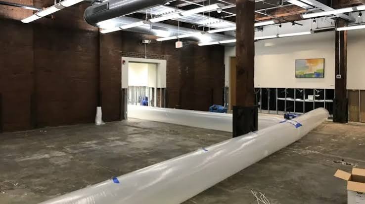 Commercial structural drying setup with lay-flat ventilation ducting and industrial dehumidification in Miami commercial space