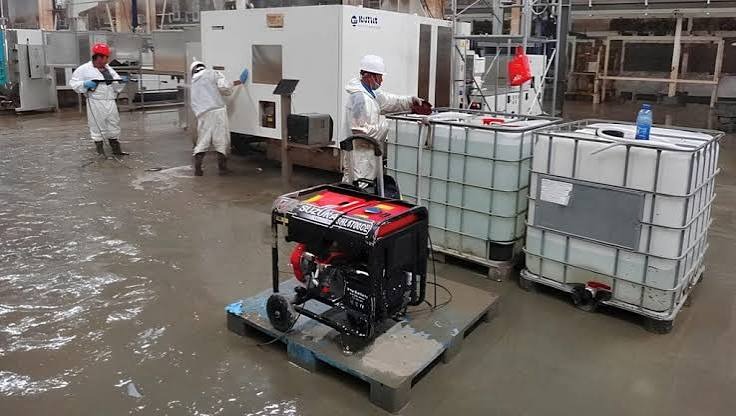 Commercial flood water removal and industrial water extraction using power generators and containment tanks in Miami facility